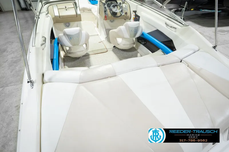 Slide: The Image of 2007 Larson LXi 228 Wakeboard Edition interior with white seating and steering console. - 17