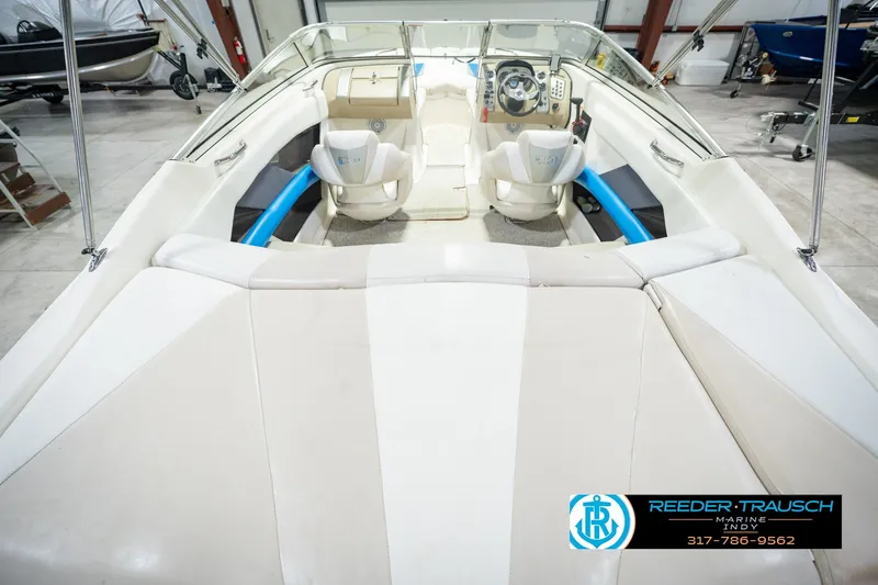 Slide: The Image of 2007 Larson LXi 228 Wakeboard Edition interior with seating and steering wheel in a showroom. - 18