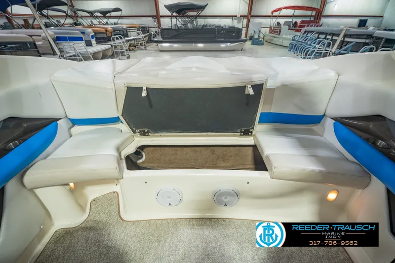 Slide: The Image of 2007 Larson LXi 228 Wakeboard Edition interior with open storage compartment in showroom. - 28