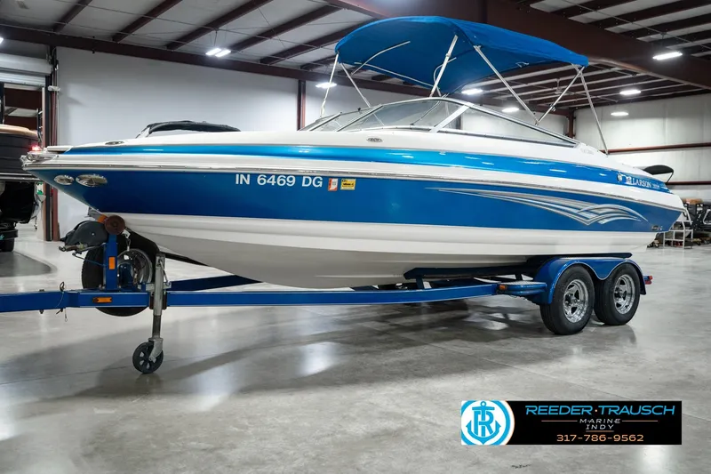 Slide: The Image of 2007 Larson LXi 228 Wakeboard Edition boat on trailer in indoor showroom. - 2