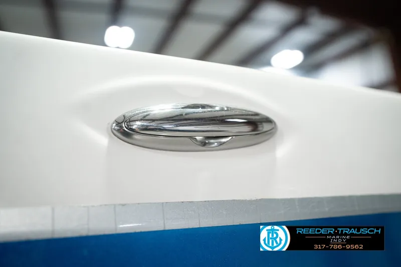 Slide: The Image of Chrome handle on 2007 Larson LXi 228 Wakeboard Edition boat, Reeder-Trausch Marine logo visible. - 62