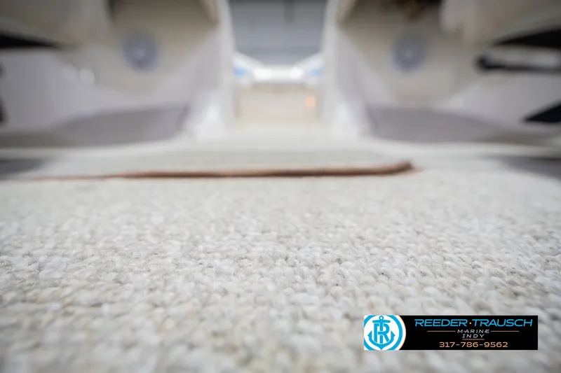 Slide: The Image of 2007 Larson LXi 228 Wakeboard Edition interior with carpet focus, Reeder-Trausch Marine logo visible. - 51
