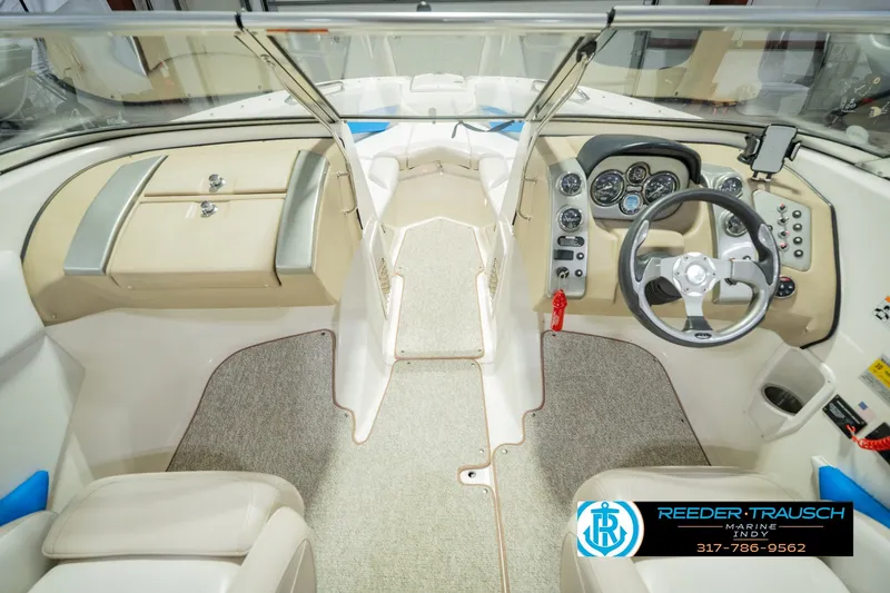 Slide: The Image of Interior view of 2007 Larson LXi 228 Wakeboard Edition boat cockpit with steering wheel and controls. - 20