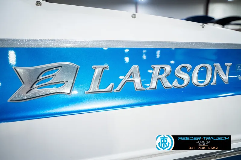 Slide: The Image of Close-up of 2007 Larson LXi 228 Wakeboard Edition boat logo on blue background. - 56
