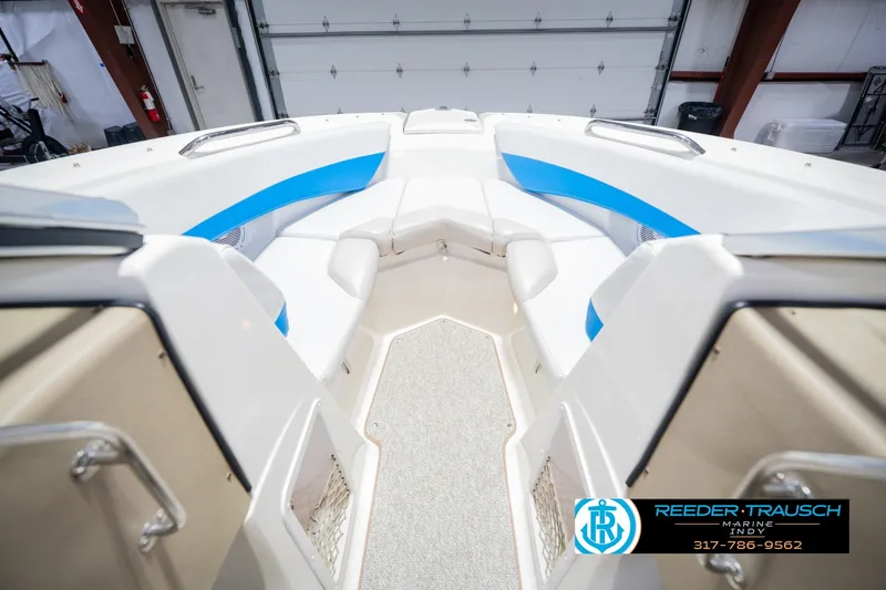 Slide: The Image of 2007 Larson LXi 228 Wakeboard Edition boat interior with blue accents in a garage. - 29