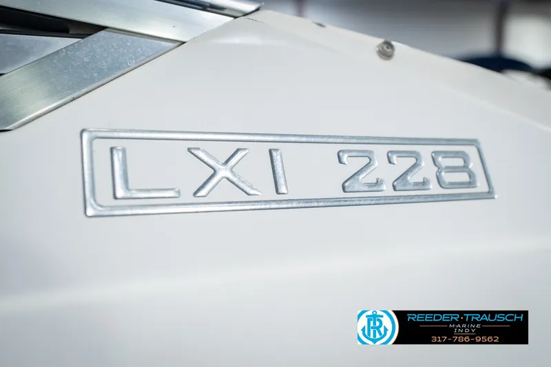 Slide: The Image of Close-up of Larson LXi 228 Wakeboard Edition 2007 boat emblem. - 57