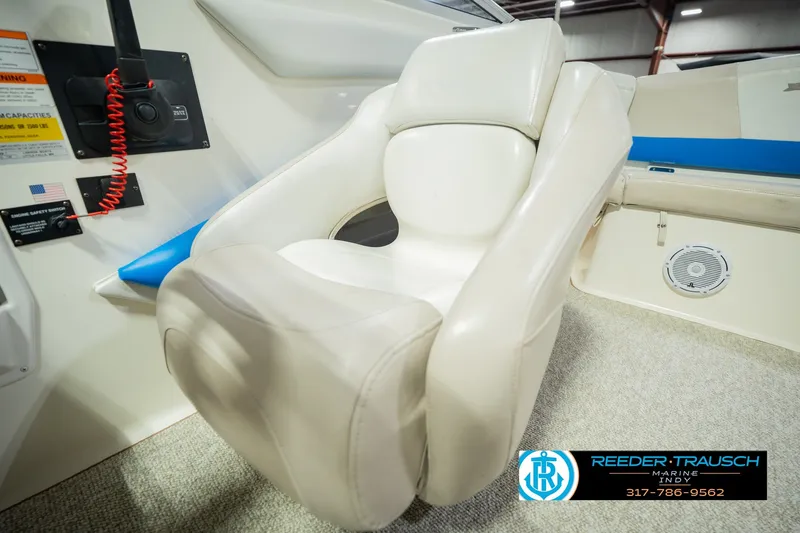 Slide: The Image of 2007 Larson LXi 228 Wakeboard Edition boat interior with plush seating and control panel. - 44