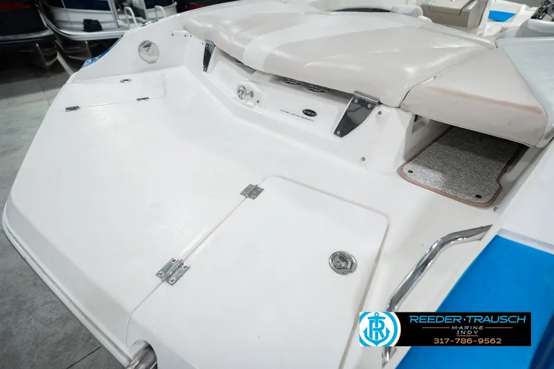 Slide: The Image of 2007 Larson LXi 228 Wakeboard Edition boat interior with white seating and storage compartments. - 61