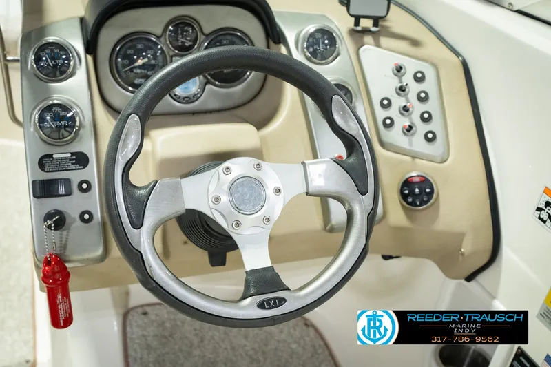 Slide: The Image of Steering wheel and dashboard of 2007 Larson LXi 228 Wakeboard Edition boat. - 33