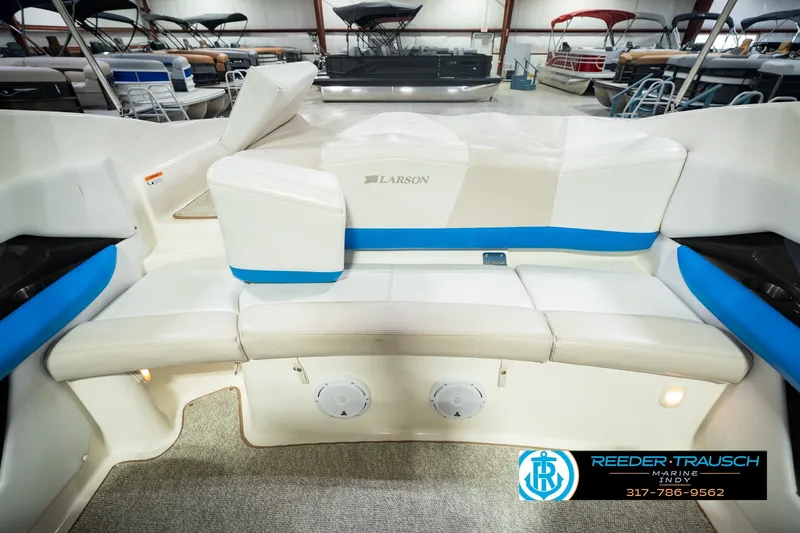 Slide: The Image of 2007 Larson LXi 228 Wakeboard Edition interior with white and blue seating in showroom. - 26