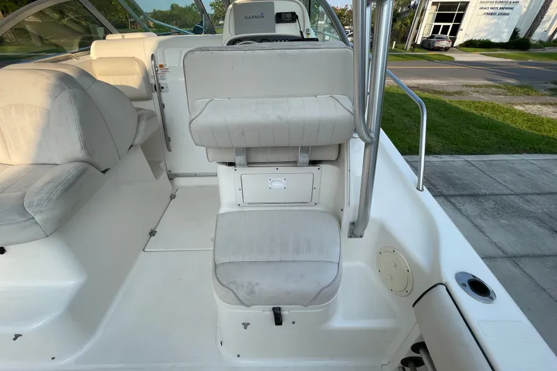 Slide: The Image of 2007 Robalo R265 Walkaround boat interior with seating and helm, featuring Garmin equipment. - 14
