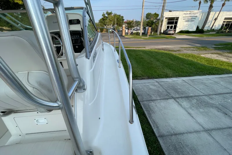 Slide: The Image of 2007 Robalo R265 Walkaround boat, side view with railing and cockpit details. - 11