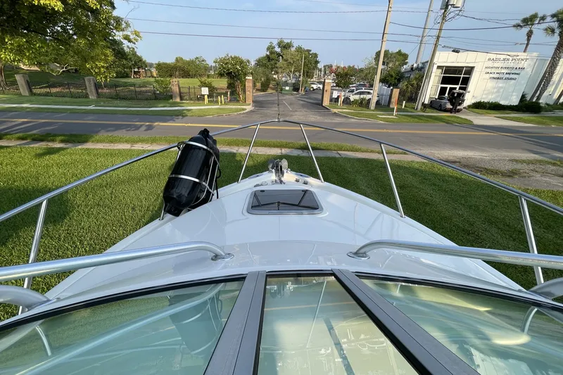 Slide: The Image of 2007 Robalo R265 Walkaround boat on grass, view from bow, sunny day. - 10