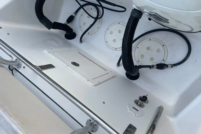 Slide: The Image of 2007 Robalo R265 Walkaround boat deck with storage hatch and wiring. - 17