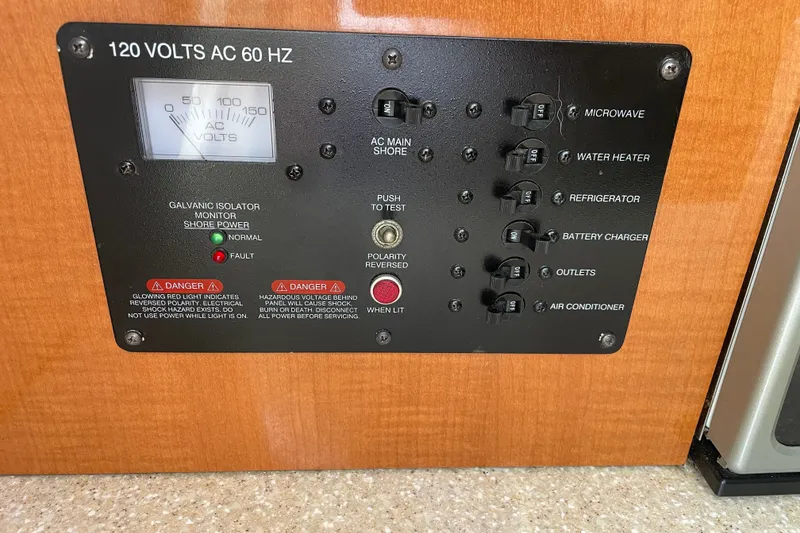 Slide: The Image of Electrical panel of a 2007 Robalo R265 Walkaround boat, featuring various switches and indicators. - 31