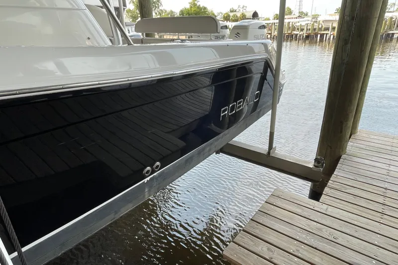 Slide: The Image of 2007 Robalo R265 Walkaround boat docked on a wooden pier. - 5
