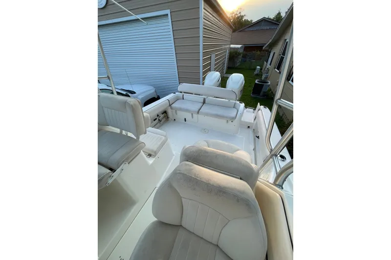 Slide: The Image of 2007 Robalo R265 Walkaround boat interior with cushioned seating and outdoor setting. - 23
