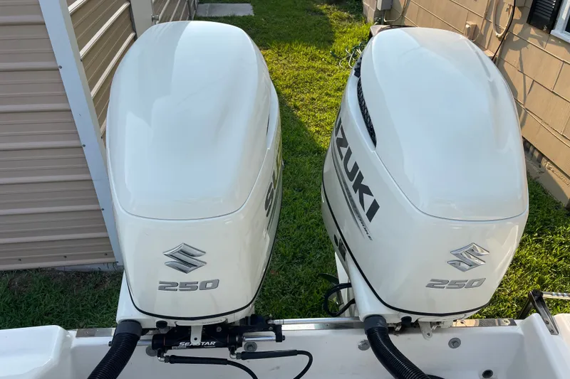 Slide: The Image of Twin Suzuki 250 outboard engines on a 2007 Robalo R265 Walkaround boat. - 8