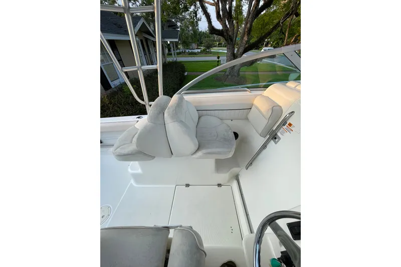 Slide: The Image of 2007 Robalo R265 Walkaround boat interior with white seating and steering wheel. - 21