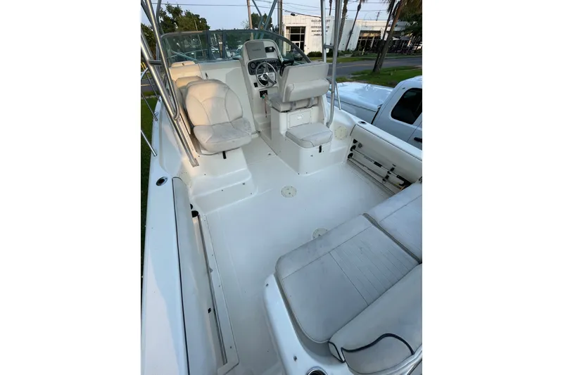 Slide: The Image of 2007 Robalo R265 Walkaround boat interior with seating and helm, showcasing spacious design. - 18