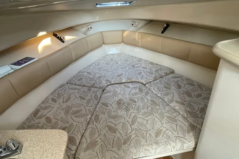 Slide: The Image of 2007 Robalo R265 Walkaround cabin interior with patterned cushions and beige upholstery. - 24
