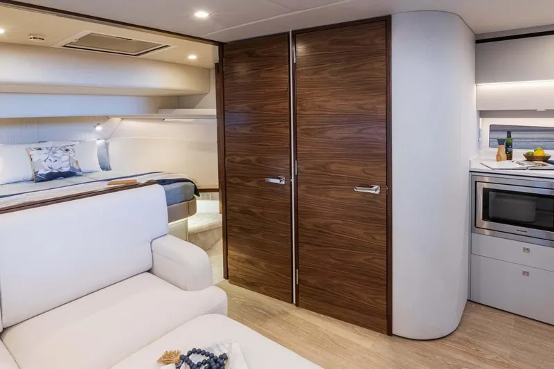 Slide: The Image of Manufacturer Provided Image: Luxurious interior of 2026 Riviera 4300 Sport Express yacht with modern kitchen and cozy bedroom. - 6