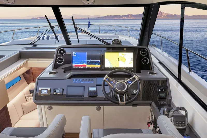 Slide: The Image of Manufacturer Provided Image: 2026 Riviera 4300 Sport Express yacht cockpit with advanced navigation screens and luxurious interior. - 9