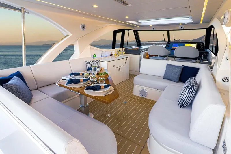 Slide: The Image of Manufacturer Provided Image: Luxurious interior of 2026 Riviera 4300 Sport Express yacht with elegant seating and dining area. - 4