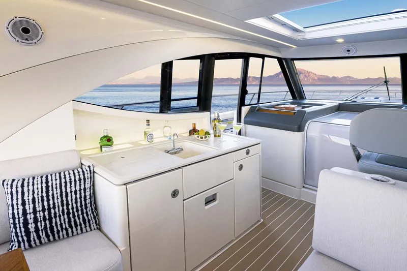 Slide: The Image of Manufacturer Provided Image: Luxurious interior of 2026 Riviera 4300 Sport Express yacht with ocean view. - 10