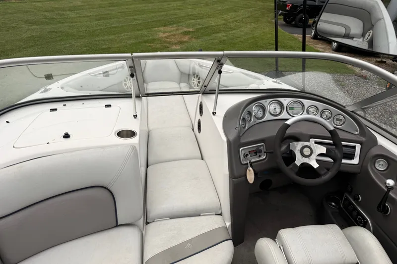 Slide: The Image of 2004 Supra Launch SSV boat interior with steering wheel and dashboard, featuring white seating. - 7