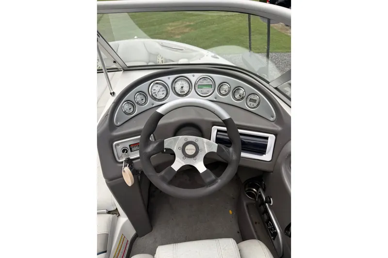Slide: The Image of 2004 Supra Launch SSV boat dashboard with steering wheel and gauges. - 6