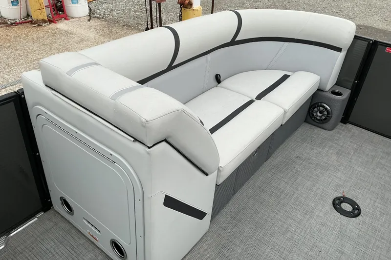 Slide: The Image of 2023 Crest Classic DLX 220 boat interior with sleek seating and integrated speakers. - 7