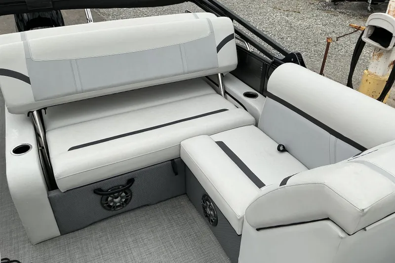 Slide: The Image of 2023 Crest Classic DLX 220 boat interior with gray seating and cup holders. - 8