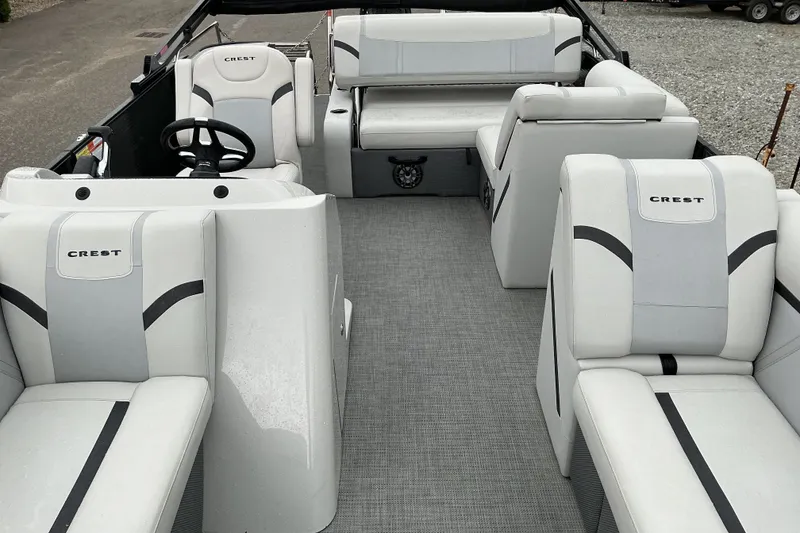 Slide: The Image of 2023 Crest Classic DLX 220 pontoon boat interior with plush seating and modern design. - 5