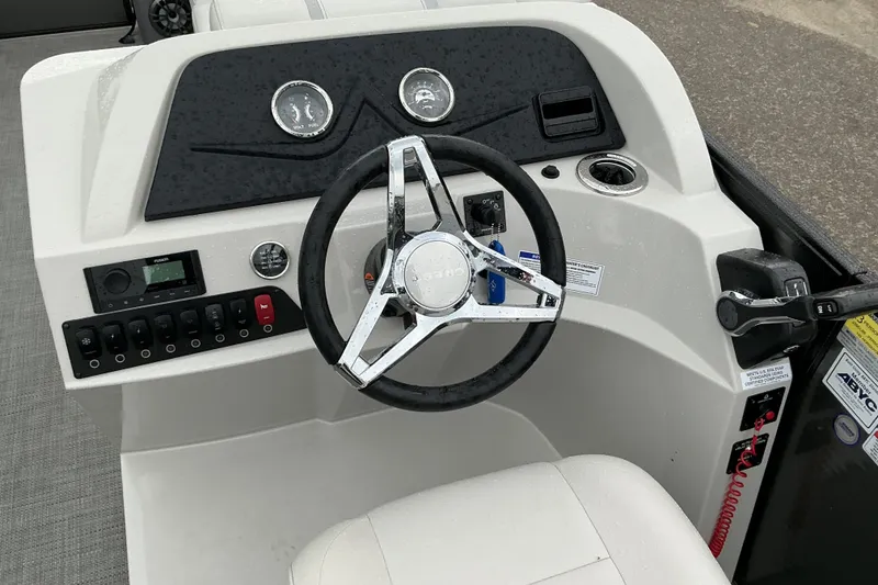 Slide: The Image of Steering console of 2023 Crest Classic DLX 220 boat with modern controls and gauges. - 11