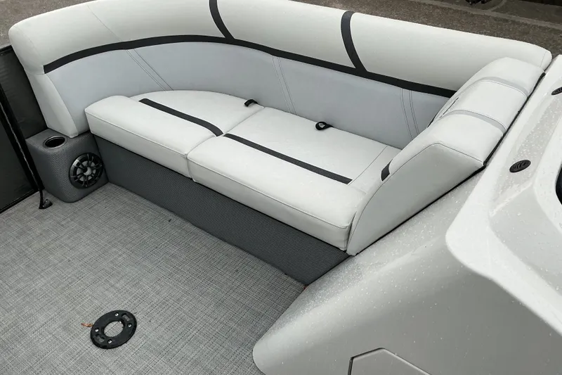 Slide: The Image of 2023 Crest Classic DLX 220 boat interior with gray seating and speaker system. - 6