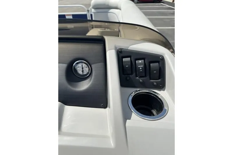 Slide: The Image of Control panel of a 2022 Bennington 2286 boat with switches and cup holder. - 15