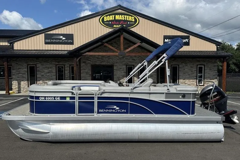 The Image of 2022 Bennington 2286 pontoon boat parked outside Boat Masters dealership. - 1