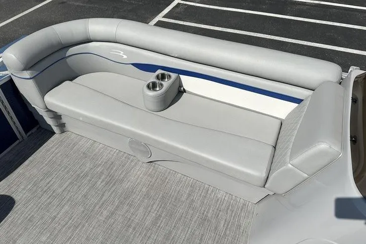 Slide: The Image of 2022 Bennington 2286 boat interior with gray seating and dual cup holders. - 16