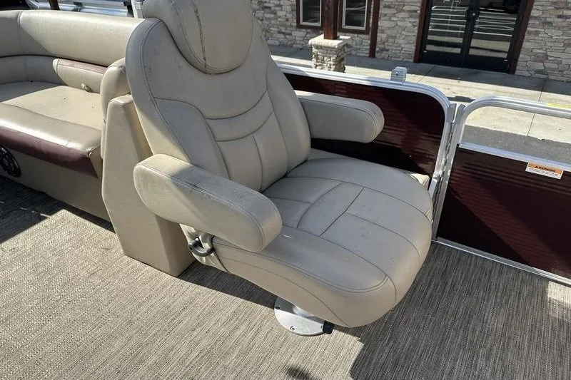 Slide: The Image of Luxurious seating on a 2022 Bennington 2286 pontoon boat, featuring plush beige upholstery. - 8