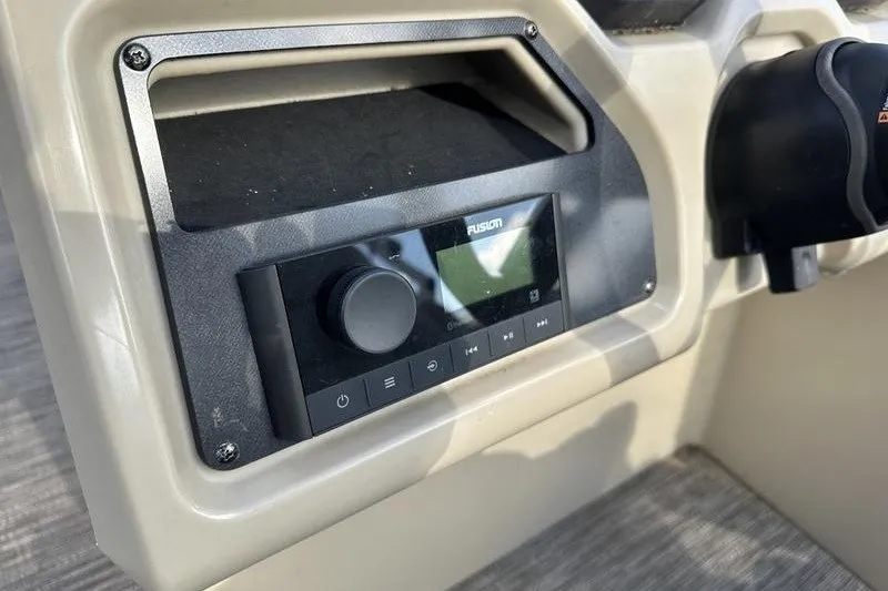 Slide: The Image of Control panel of a 2022 Bennington 2286 boat featuring a Fusion audio system. - 2