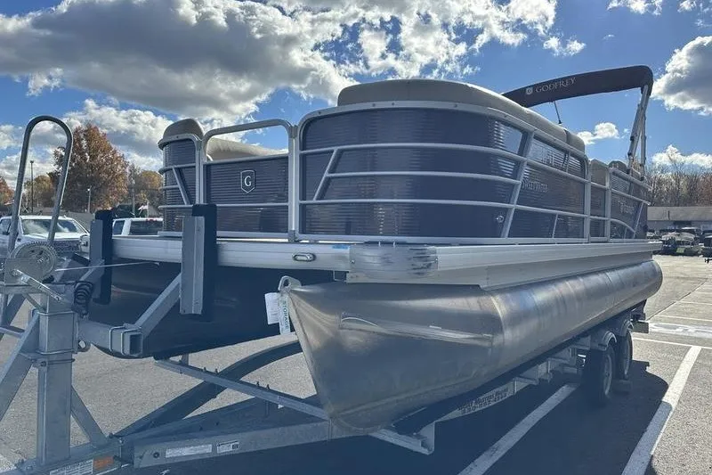 Slide: The Image of 2022 Bennington 2286 pontoon boat on trailer under a partly cloudy sky. - 5