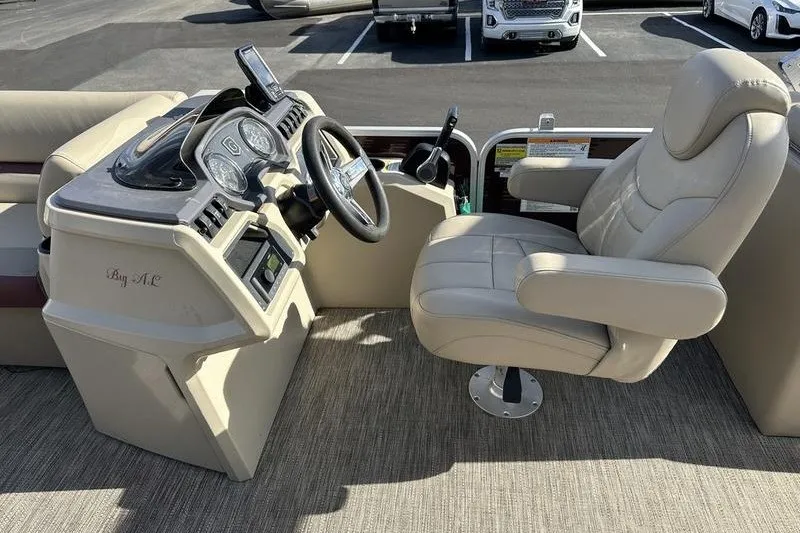 Slide: The Image of Captain's chair and helm of 2022 Bennington 2286 pontoon boat, featuring modern controls. - 19