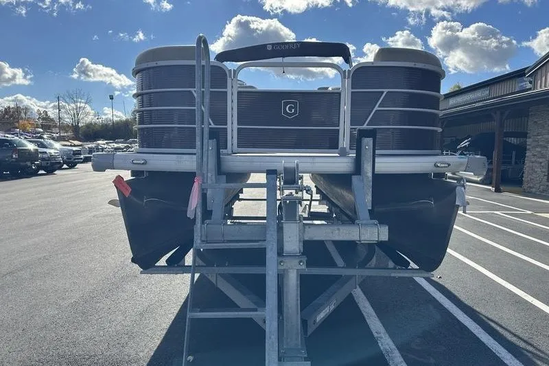 Slide: The Image of 2022 Bennington 2286 pontoon boat on trailer in parking lot under blue sky. - 3