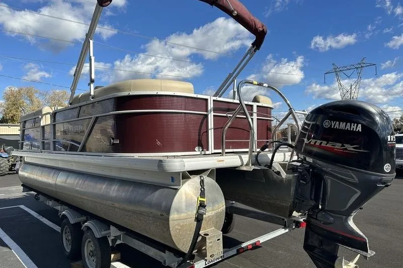Slide: The Image of 2022 Bennington 2286 pontoon boat with Yamaha engine on trailer under blue sky. - 13