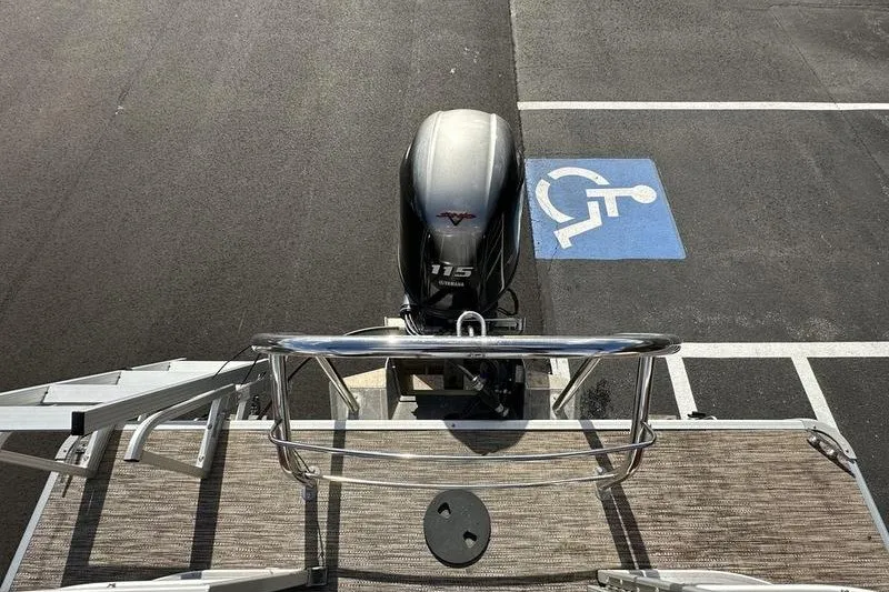 Slide: The Image of Bennington 2286 boat with Yamaha 115 engine parked near a handicap space, 2022 model. - 6