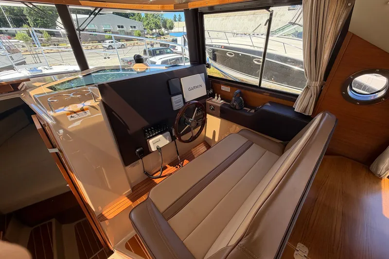 Slide: The Image of Interior of 2020 Ranger Tugs R-29 S boat with helm station and seating. - 15