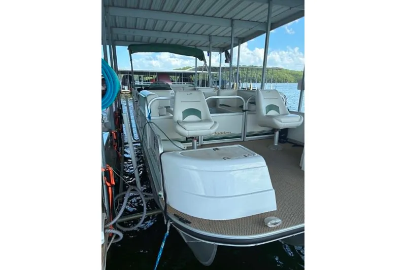 Slide: The Image of 2001 Landau DX 24 pontoon boat docked under a covered marina. - 9
