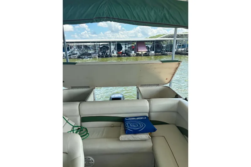 Slide: The Image of Interior view of a 2001 Landau DX 24 boat with open storage compartment. - 8