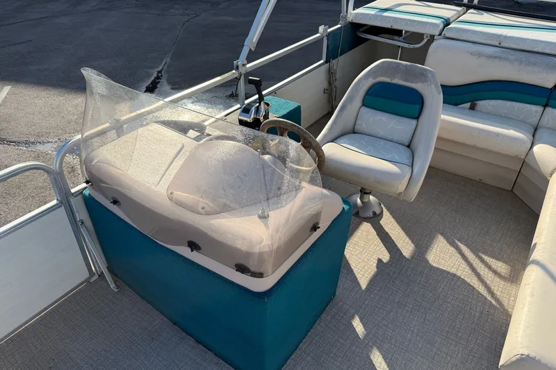 Slide: The Image of 1998 Lowe Family 245 boat interior with steering console and seating. - 13